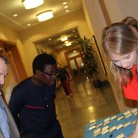 People gathered around the welcome table, looking at nametags